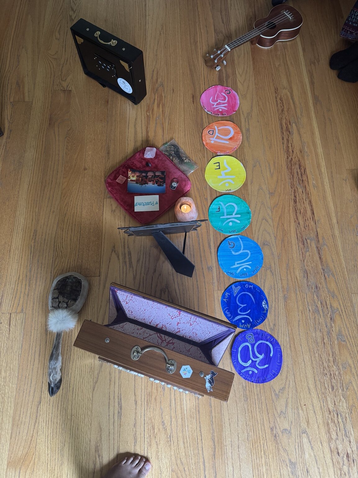 Shruti boxes and handmade chakra symbols arranged for singing meditation