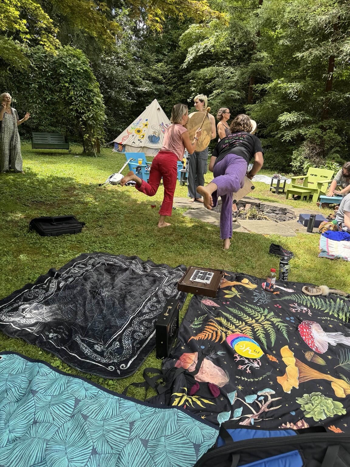Community members sounding and playing drums together outdoors