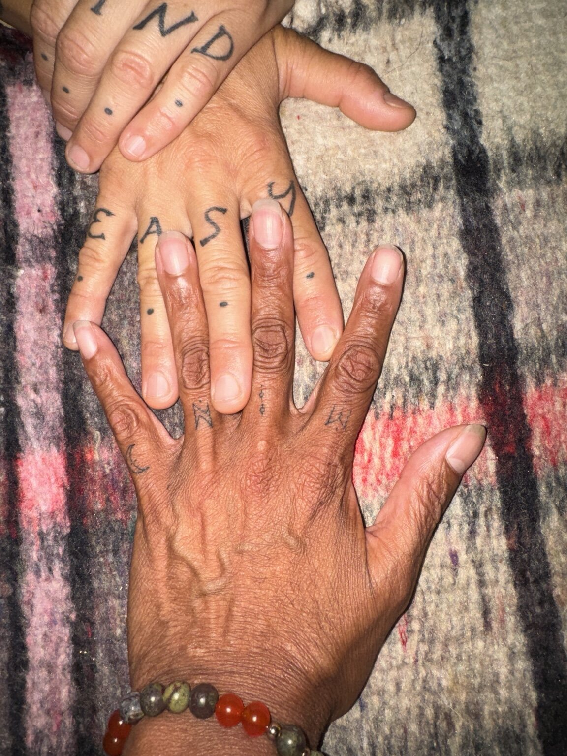 Three community members joining hands